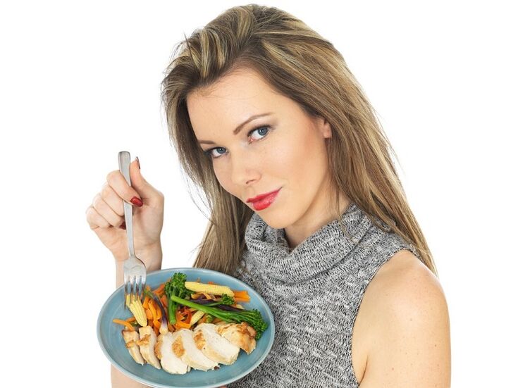 menina comendo frango com vegetais para perder peso